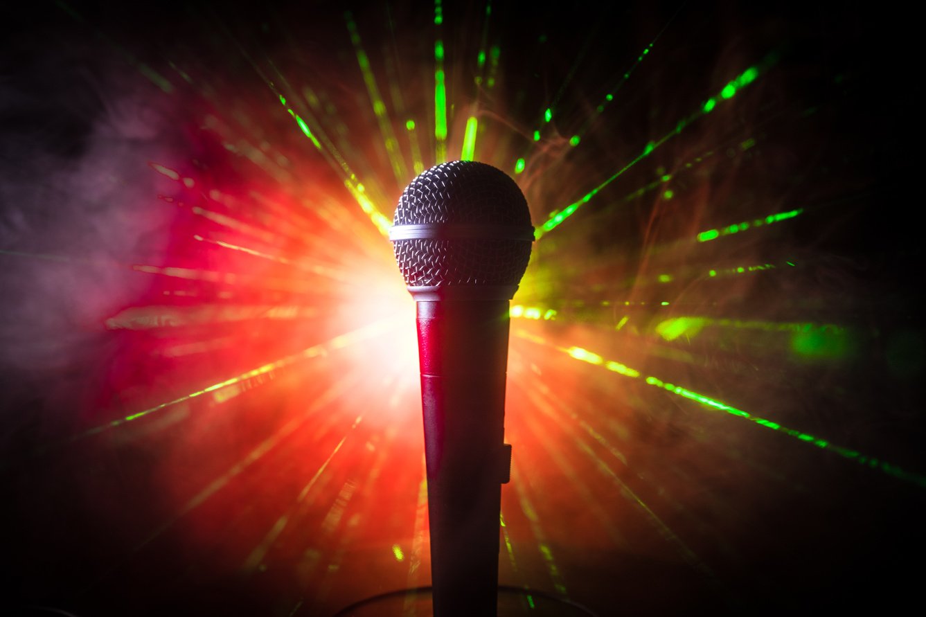 a microphone in front of a red and green light. Microphone in a Tesla car, used for playing songs and interacting with voice-activated features.