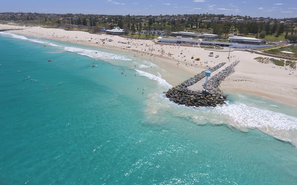 an aerial view of a beach with people swimming in the water at Trigg beach perth australia , karaoke in tesla car